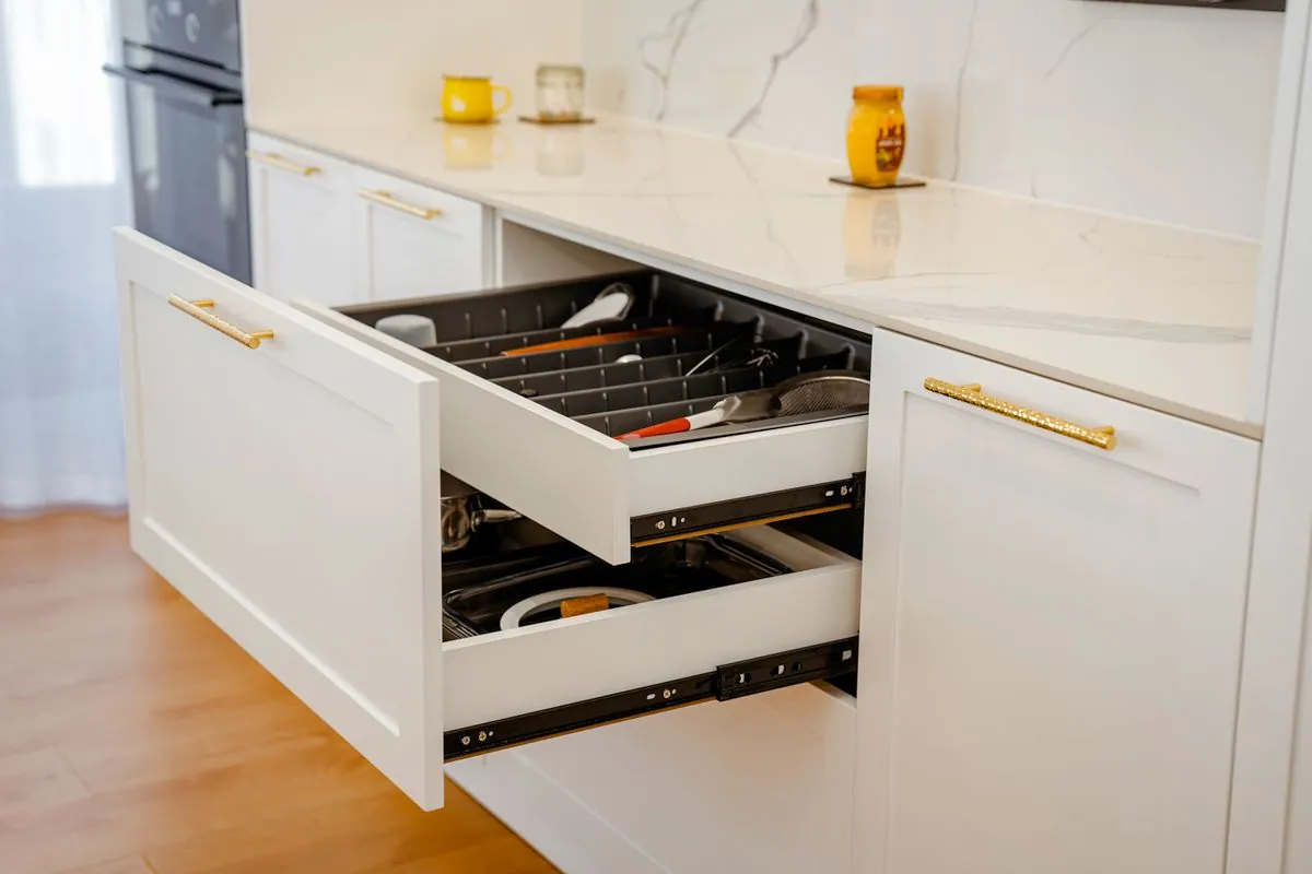 A drawer with brass handles pulled open